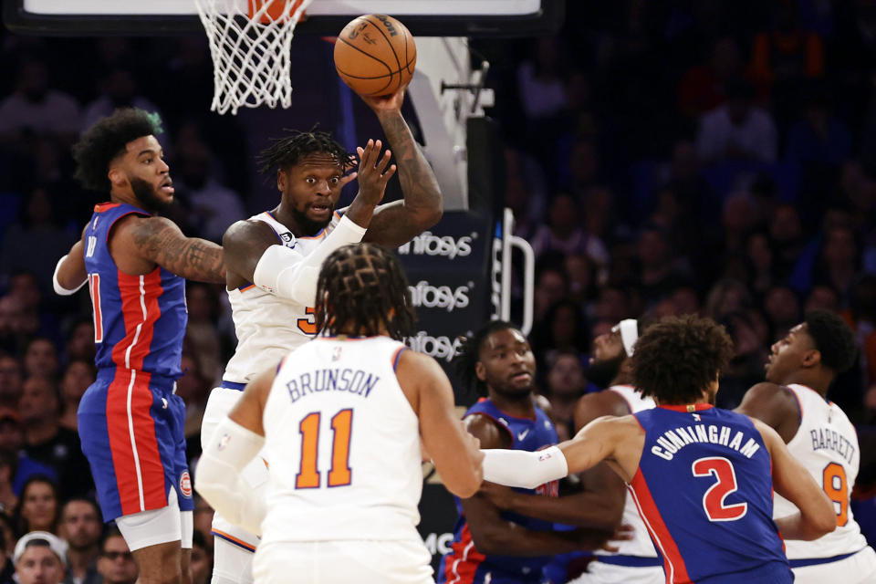New York Knicks forward Julius Randle (30) looks to pass the ball in front of Detroit Pistons forward Saddiq Bey, left, during the first half of an NBA basketball game Friday, Oct. 21, 2022, in New York. (AP Photo/Adam Hunger)