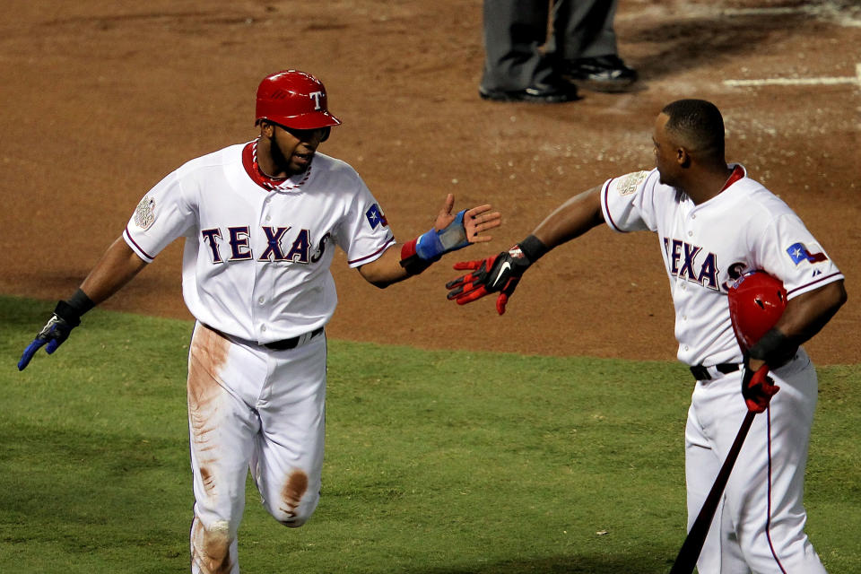 ARLINGTON, TX - OCTOBER 23: Elvis Andrus #1 of the Texas Rangers celebrates with Adrian Beltre #29 after scoring in the first inning during Game Four of the MLB World Series against the St. Louis Cardinals at Rangers Ballpark in Arlington on October 23, 2011 in Arlington, Texas. (Photo by Doug Pensinger/Getty Images)