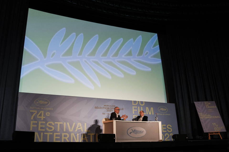 Festival director Thierry Fremaux, left and Festival president Pierre Lescure speak during the press conference for the presentation of the official selection of the 74th International Cannes Film Festival, in Paris, Thursday, June 3, 2021. (AP Photo/Francois Mori)