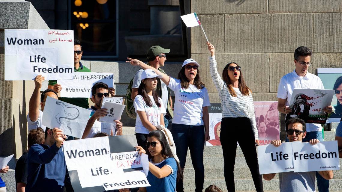 Asal Syes, center left, and Afagh Faramarzi, with an Iranian flag, lead a chant during a rally at the Idaho Capitol against the treatment of women in Iran, on Saturday, Oct. 1, 2022. Protesters have been demonstrating against the Middle Eastern nation’s authoritarian government after the death of Mahsa Amini, a 22-year-old woman who last month was taken into police custody for allegedly disobeying the nation’s dress code for women.