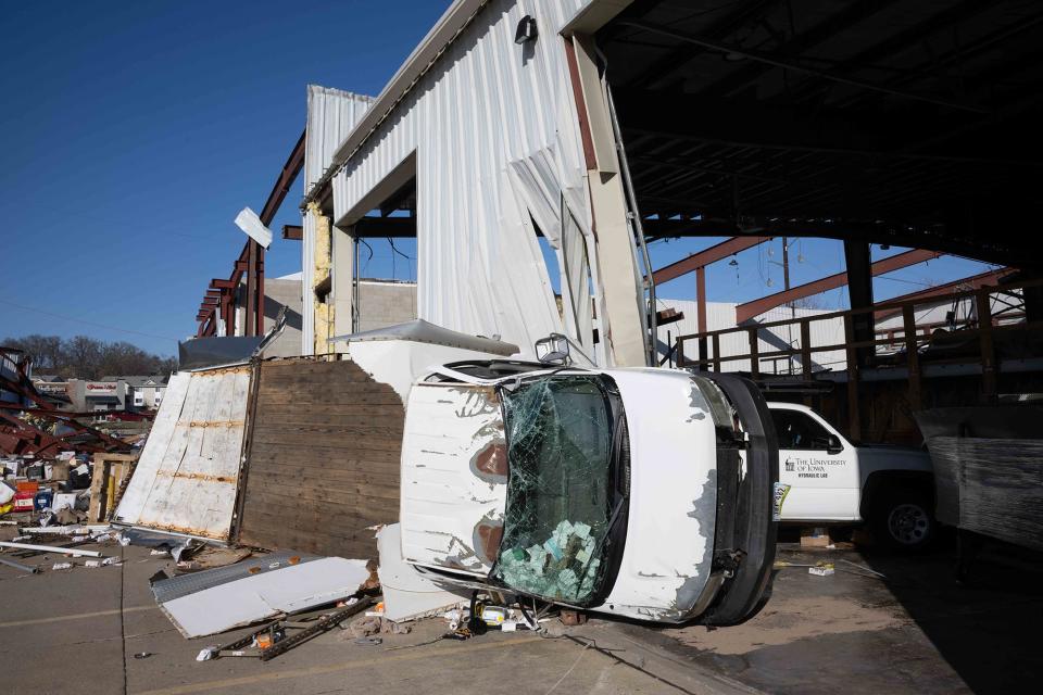 Damaged vehicles in the wreckage of the University of Iowa's James Street Lab in Coralville after a March 31 tornado.