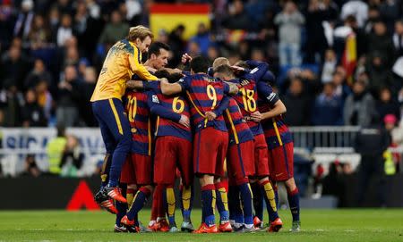 Barcelona players celebrate winning after the match. Reuters / Stringer