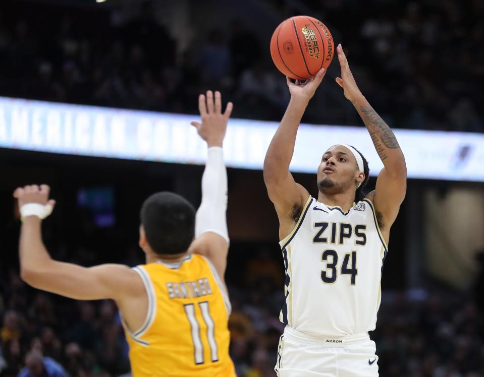 Akron's Nate Johnson shoots over Kent State's Giovanni Santiago during Mid-American Conference Tournament championship game Saturday in Cleveland.