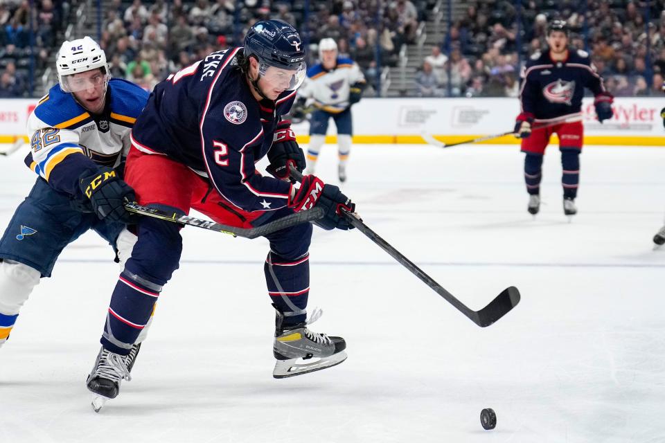 Oct 6, 2022; Columbus, Ohio, United States; Columbus Blue Jackets defenseman Andrew Peeke (2) contests the puck with St. Louis Blues forward William Bitten (42) during the second period of the preseason game at Nationwide Arena. Mandatory Credit: Joseph Scheller-The Columbus Dispatch