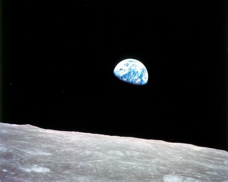 This file image, released by NASA, shows the Earth rising over the moon, as seen on Christmas Eve, December 24, 1968 from Apollo 8, the first manned mission to the moon, as it entered lunar orbit. Two former top NASA officials have unveiled plans to sell manned flights to the moon by the end of the decade, in an announcement 40 years after the last human set foot there