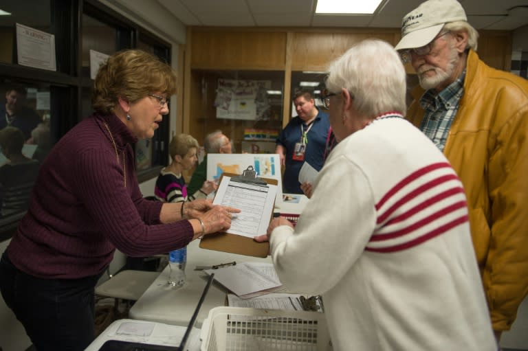Iowa election officials check in voters prior to the Republican Party Caucus at Keokuk High School, on February 1, 2016