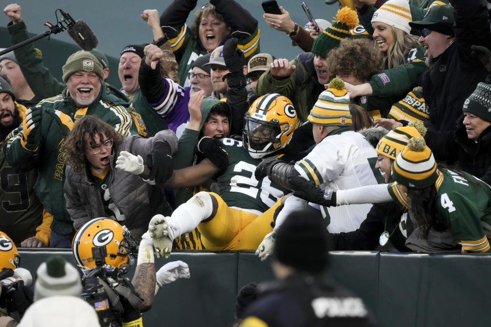 Green Bay Packers safety Darnell Savage (26) celebrates with fans after returning an interception 75 yards for a touchdown during the first half of an NFL football game against the Minnesota Vikings, Sunday, Jan. 1, 2023, in Green Bay, Wis. (AP Photo/Morry Gash)