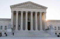PHOTO: The sun rises behind the U.S. Supreme Court, Oct. 11, 2022, in Washington. (Alex Brandon/AP)