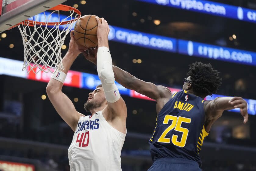 Los Angeles Clippers center Ivica Zubac, left, grabs a rebound away from Indiana Pacers forward Jalen Smith during the second half of an NBA basketball game Sunday, Nov. 27, 2022, in Los Angeles. (AP Photo/Mark J. Terrill)