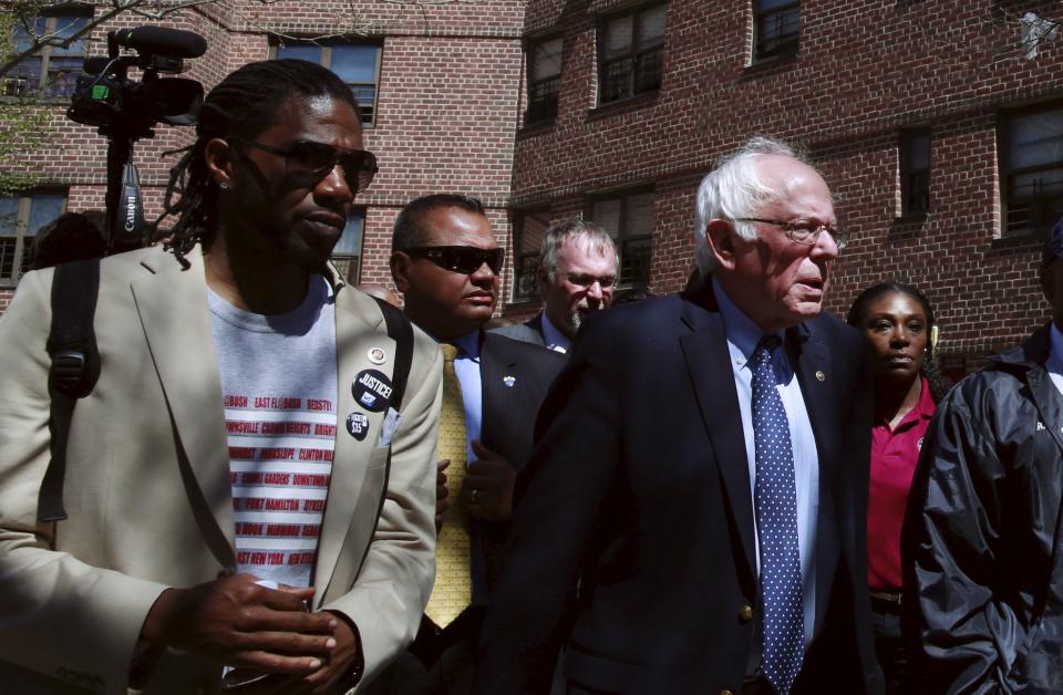 New York City Council member&nbsp;Jumaane Williams walks with then-presidential candidate Sen. Bernie Sanders through a housing complex in Brooklyn in April 2016. (Photo: Lucas Jackson / Reuters)