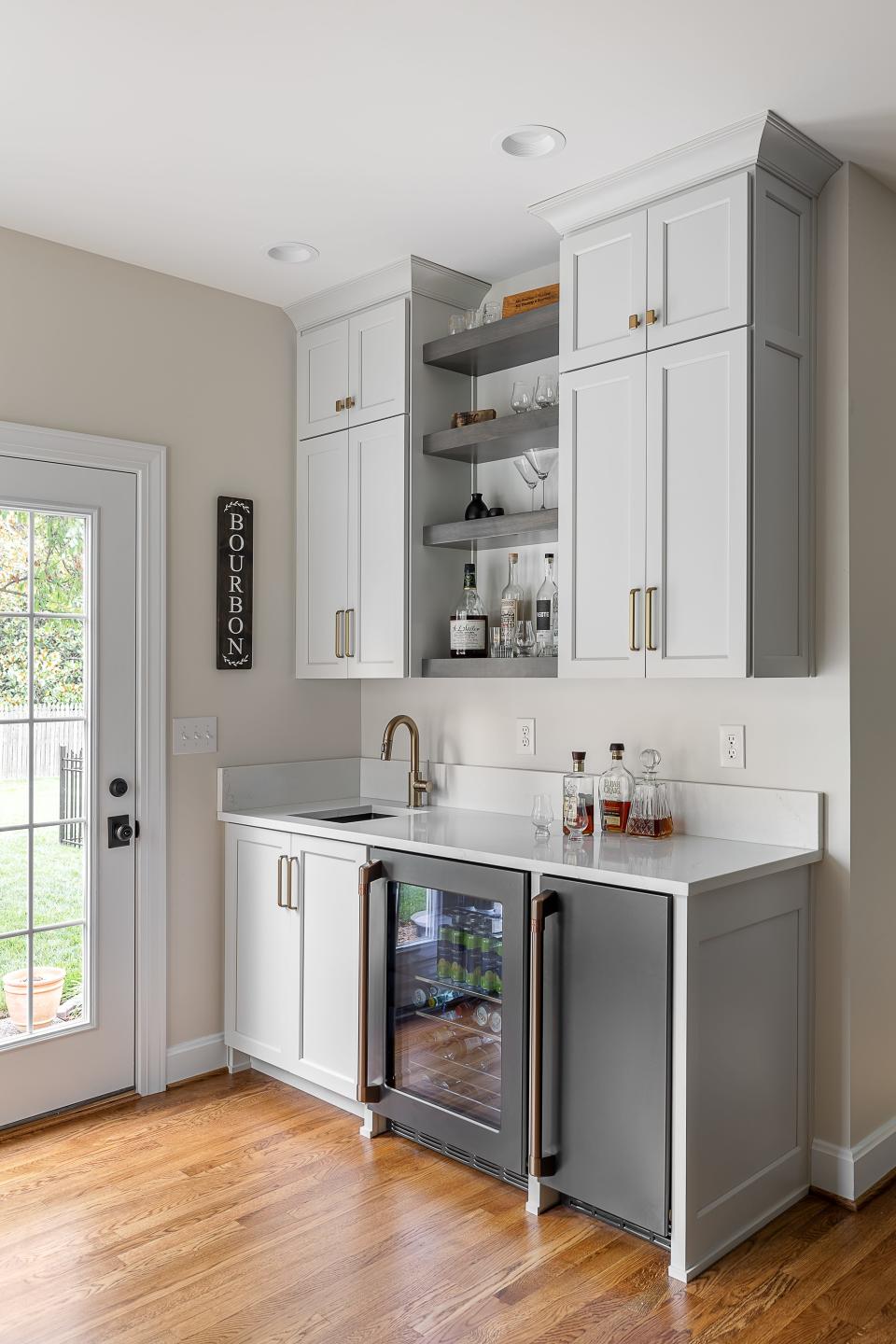 A bar area provides a space specifically crafted for wine, beer, and cocktails at this remodeled home in Plainview.