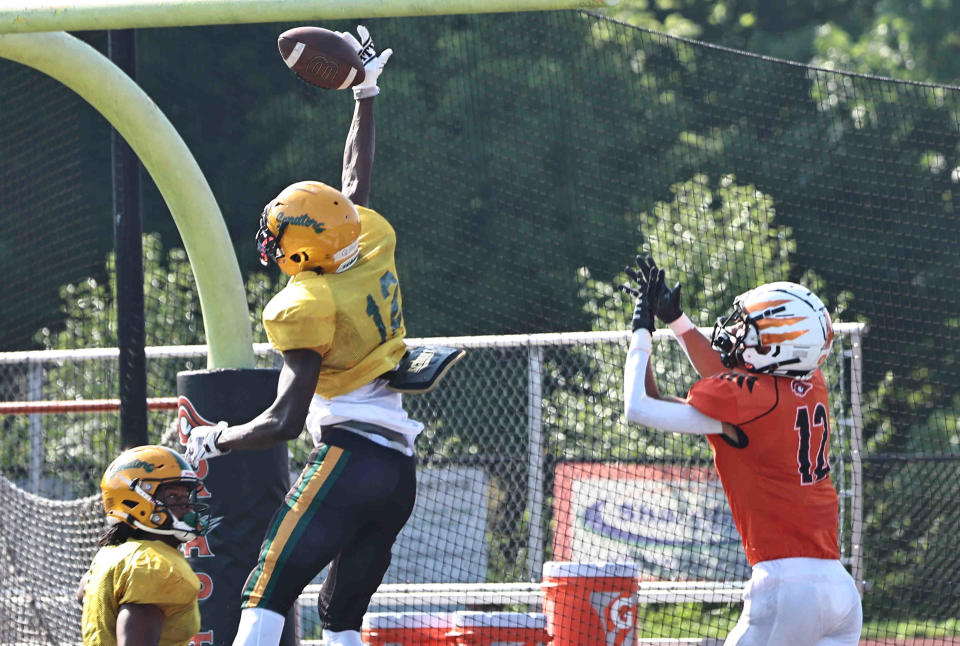 Taft defensive back Quinton Price (12), who has committed to UC, breaks up a pass intended for Trace Jallick (12) during their scrimmage Friday, Aug. 4, 2023.