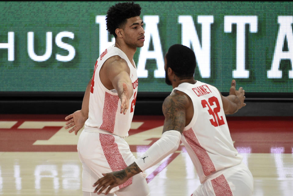 Houston guard Quentin Grimes, left, celebrates his three point basket with Reggie Chaney during the first half of an NCAA college basketball game against Cincinnati, Sunday, Feb. 21, 2021, in Houston. (AP Photo/Eric Christian Smith)