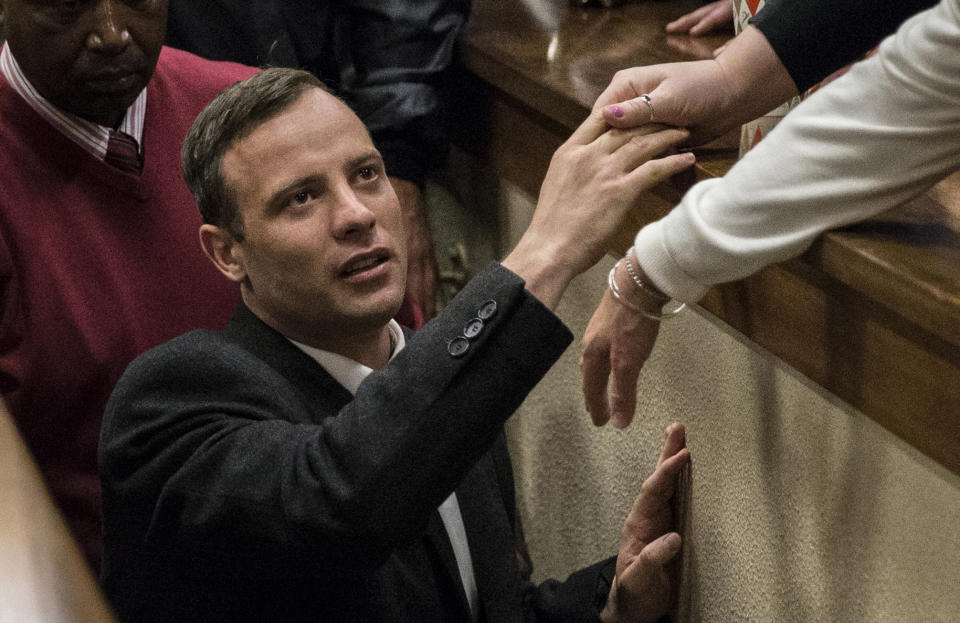 FILE — Oscar Pistorius leaves the High Court in Pretoria, South Africa, Wednesday, July 6, 2016 after a judge passed a new sentence of six years imprisonment after his conviction was changed to murder for shooting girlfriend Reeva Steenkamp in 2013. Pistorius shot his girlfriend Reeva Steenkamp more than a decade ago in a Valentine's Day killing that jolted the world and shattered the image of a sports superstar. (Marco Longari, Pool Photo via AP/File)