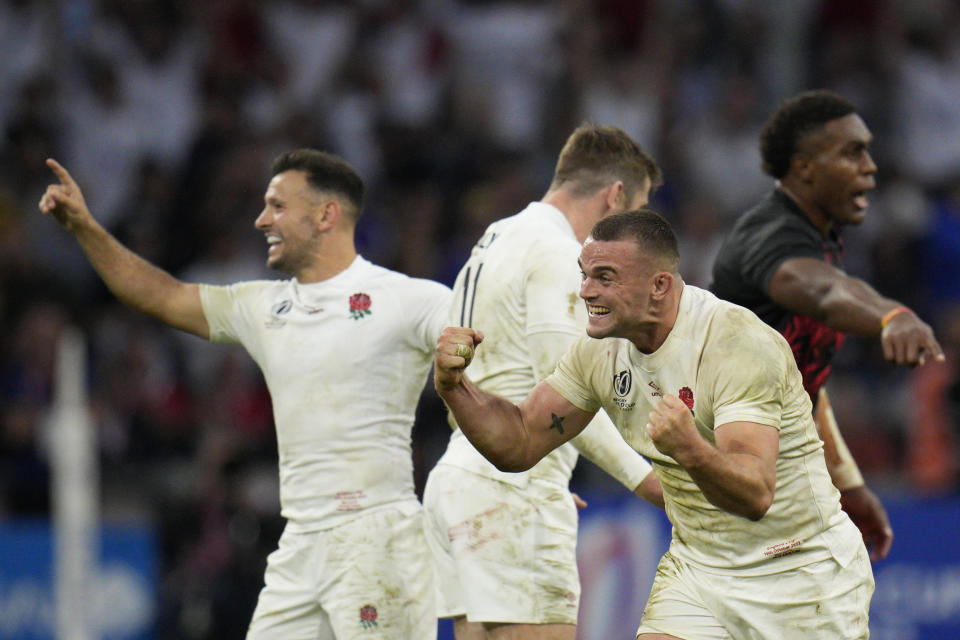 England's Ben Earl, right, celebrates winning the Rugby World Cup quarterfinal match between England and Fiji at the Stade de Marseille in Marseille, France, Sunday, Oct. 15, 2023. (AP Photo/Daniel Cole)