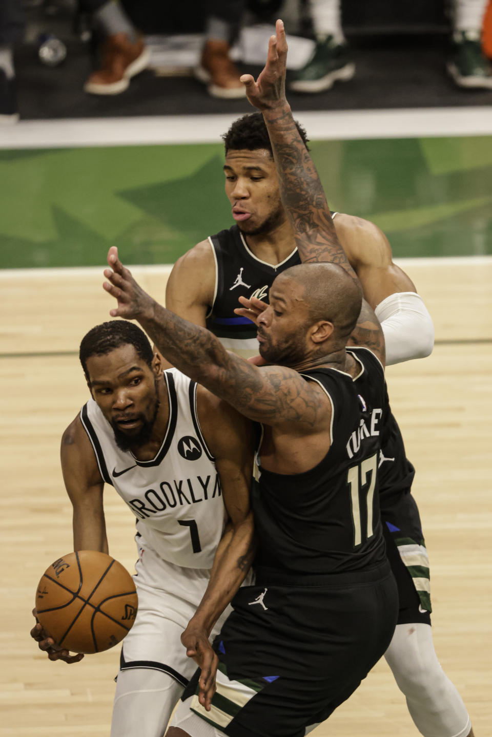 Brooklyn Nets' Kevin Durant (7) is guarded by Milwaukee Bucks forward P.J. Tucker (17) during the second half of Game 6 of a second-round NBA basketball playoff series Thursday, June 17, 2021, in Milwaukee. (AP Photo/Jeffrey Phelps)