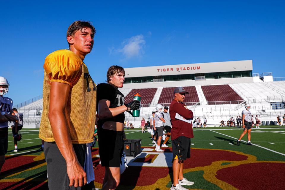Dripping Springs quarterback Austin Novosad watches the second string team run drills. The Dripping Springs varsity football team held an early-morning practice in the Dripping Springs High School stadium on Thursday, Aug. 12, 2021.