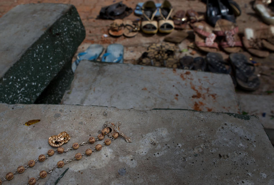 In this April 22, 2019, file photo, a set of rosary beads, footwear and personal belongings of victims are scattered at the scene of a suicide bombing at St. Sebastian Church in Negombo, Sri Lanka. (AP Photo/Gemunu Amarasinghe, File)