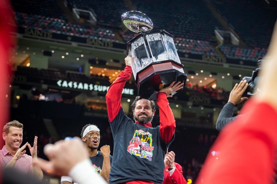 Head coach Michael Desormeaux holds the trophy as The Louisiana Ragin Cajuns beat Marshall University 26-21 to win The 2021 R & L Carriers New Orleans Bowl at the Caesars Superdome in New Orleans.  Friday, Dec. 18, 2020.