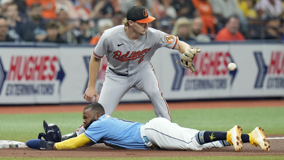 Tampa Bay Rays' Manuel Margot slides into third base safely ahead of the throw to Baltimore Orioles third baseman Gunnar Henderson (2) on a fly out by Christian Bethancourt during the second inning of a baseball game Wednesday, June 21, 2023, in St. Petersburg, Fla. (AP Photo/Chris O'Meara)