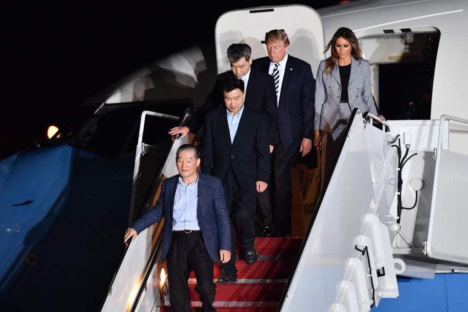 <p>President Donald Trump (2nd R) and his wife Melania Trump (R) walk down the stairs with U.S. detainees Tony Kim (2nd L), Kim Dong-chul (bottom L) and Kim Hak-song (C) upon their return after they were freed by North Korea, at Joint Base Andrews in Maryland on May 10, 2018. (Photo: Nicholas Kamm/AFP/Getty Images) </p>