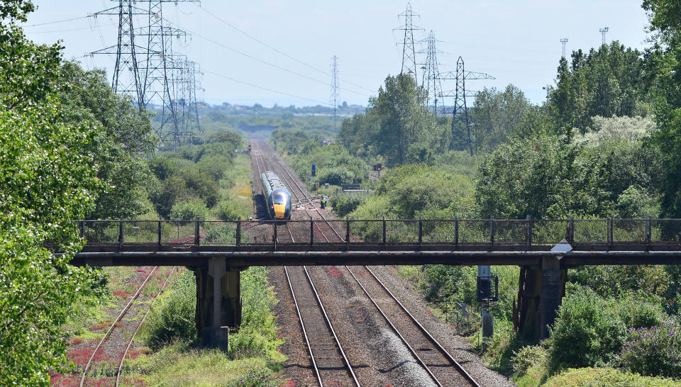 The scene of the crash where two rail workers have died after being hit by a passenger train at Margam between Port Talbot Parkway and Bridgend stations. July 3, 2019.  The pair were struck near Margam by the Swansea to London Paddington train at about 10:00 BST.  They were pronounced dead at the scene and a third person was treated for shock, but was not injured, British Transport Police (BTP) said.  Network Rail said it was "shocked and distressed" that "two members of our team lost their lives".  Bill Kelly, the company's route managing director for Wales, added: "We are fully cooperating with the British Transport Police and Rail Accident Investigation Branch.