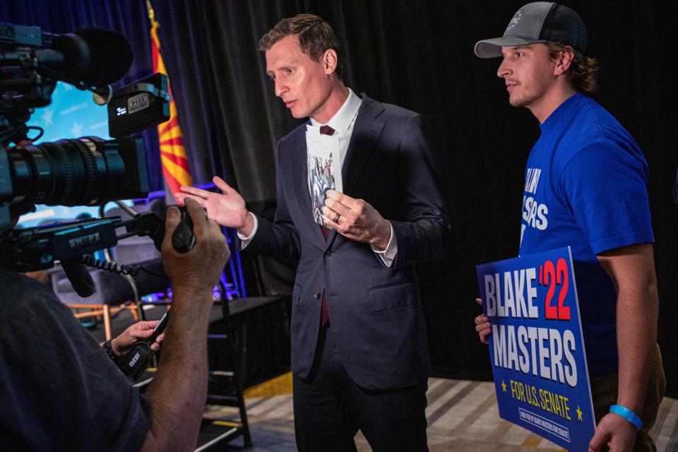 Blake Masters stops to talk with reporters at the end of the Republican primary debate for the U.S Senate in Phoenix on June 23, 2022.