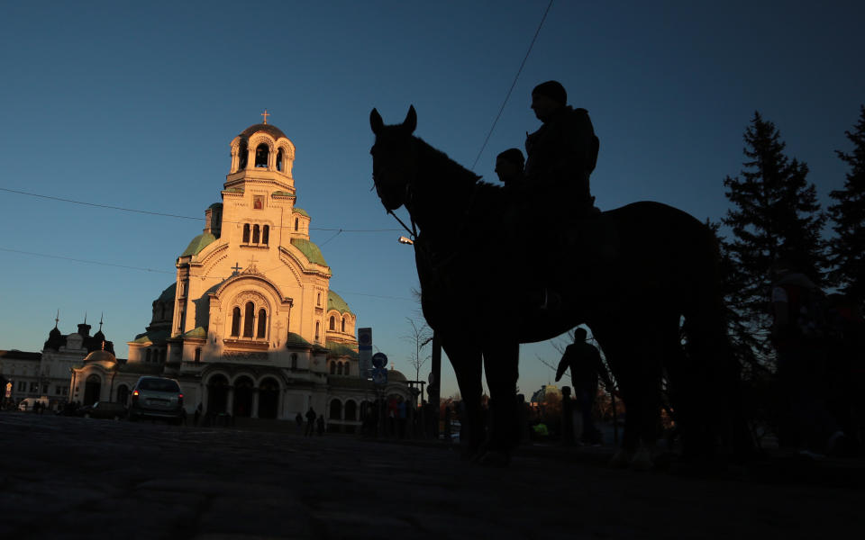 Bulgarian policeman sit on horseback prior to a far-right nationalists march in front of Alexander Nevsky cathedral in Sofia, Saturday, Feb., 15 2014. Hundreds of Bulgarian nationalists have marched through the capital to honor a World War II general known for his anti-Semitic and pro-Nazi activities, although Sofia's mayor had banned Saturday's rally, organized by the far-right Bulgarian National Union.(AP Photo/Valentina Petrova)
