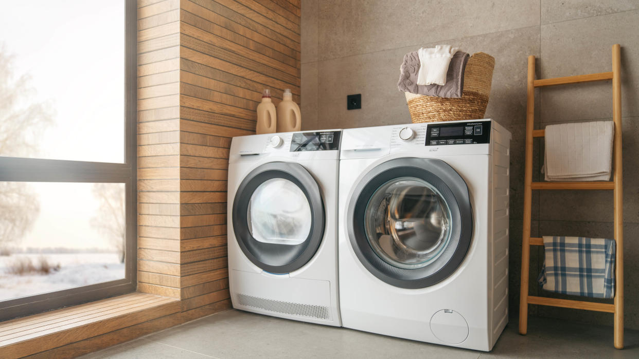  A washing machine and clothes dryer in a laundry room to help you visualize the gas dryer vs electric choice 