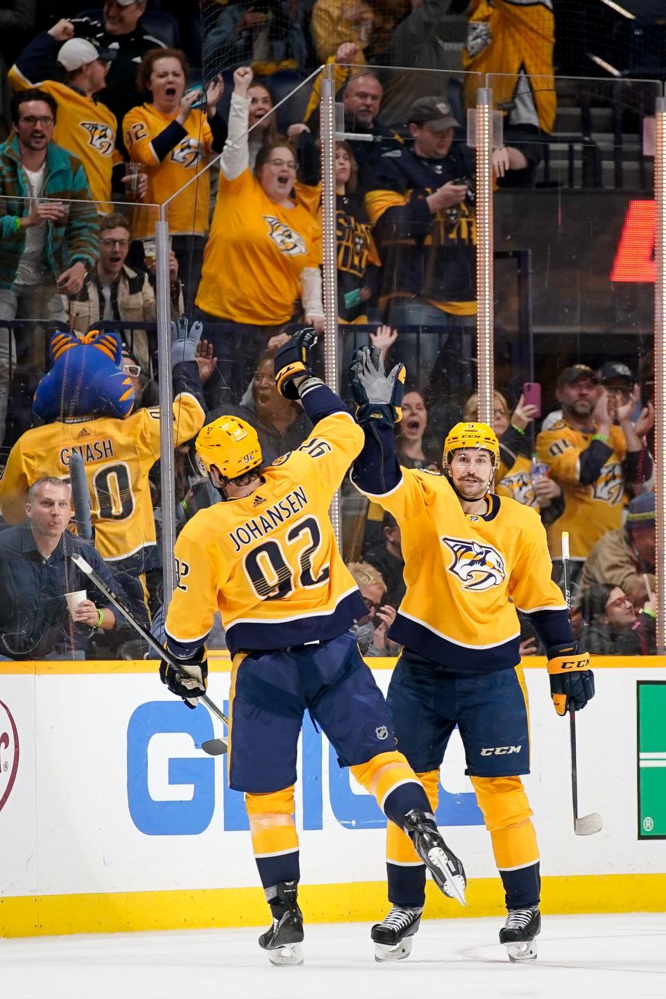 Nashville Predators left wing Filip Forsberg (9) celebrates his goal against the Calgary Flames with center Ryan Johansen (92) during the second period at Bridgestone Arena in Nashville, Tenn., Tuesday, April 19, 2022.