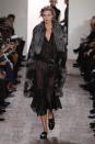 <p>Karlie Kloss walked the Michael Kors 2014 fall fashion show in a sheer dress, fur coat, and belt.</p>
