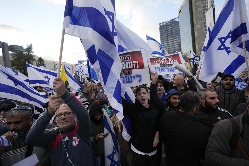 File - Right-wing Israelis rally in support of Prime Minister Benjamin Netanyahu's government plans to overhaul the judicial system, in Tel Aviv, Israel, Thursday, March 30, 2023. As Israel turns 75, it has much to celebrate. But instead of feting its accomplishments as a regional and economic powerhouse, the nation founded as a home for the world's Jews in the wake of the Holocaust finds itself under threat -- not by foreign enemies but by bitter internal divisions. (AP Photo/Ariel Schalit, File)