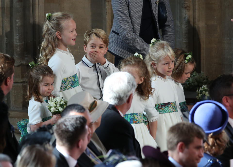 The bridesmaids and page boys, including Princess Charlotte of Cambridge (L), Savannah Phillips (2L) and Prince George of Cambridge (3L) wait to take part in the wedding of Britain's Princess Eugenie of York to Jack Brooksbank at St George's Chapel, Windsor Castle, in Windsor, on October 12, 2018. (Photo by Yui Mok / POOL / AFP) (Photo credit should read YUI MOK/AFP/Getty Images)