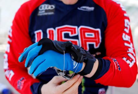 U.S. Olympic athlete Connor Fields protects his healing broken hand with a brace before climbing on his BMX to work out at the Olympic Training Center in Chula Vista, California, United States, July 1, 2016. REUTERS/Mike Blake