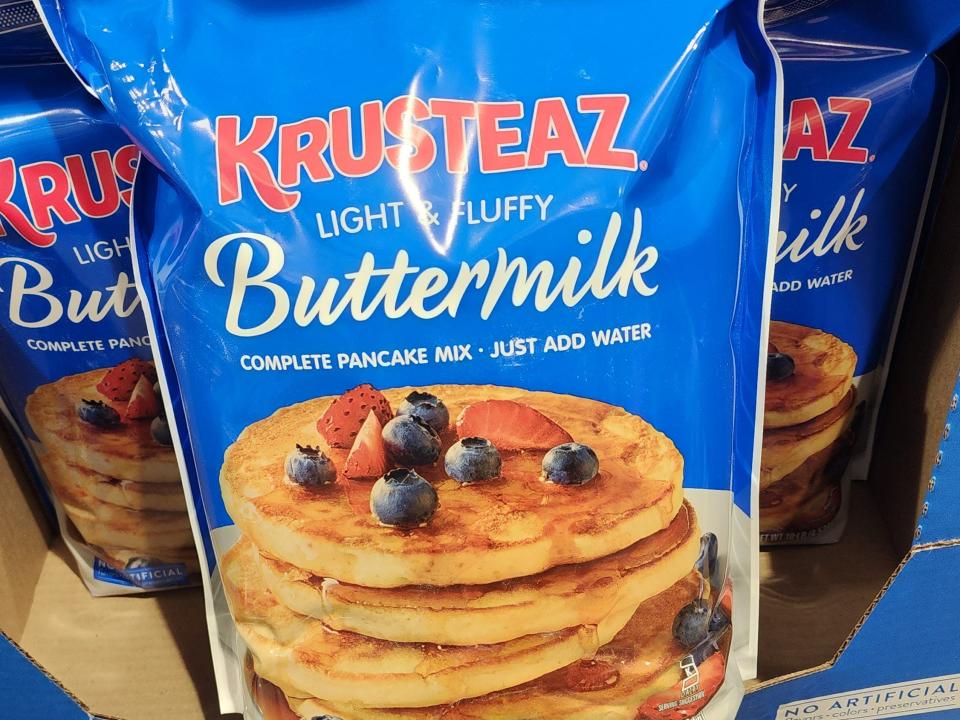 A bright-blue bag of Krusteaz buttermilk pancake mix on the shelf at Costco