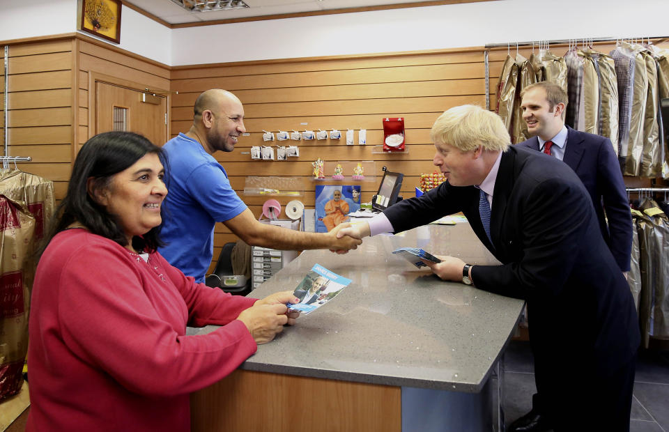 Mayor of London Boris Johnson with Conservative candidate for Kingston and Surbiton James Berry (right) talking to local shopkeepers while on the General Election campaign trail in New Malden in south-west London.