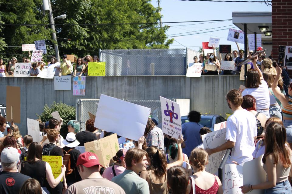 Protesters flood the back parking lot of the Women's Care Center around 4:30 p.m. June 27. They allege the center misleads pregnant people with dangerous information to coerce them out of having an abortion.