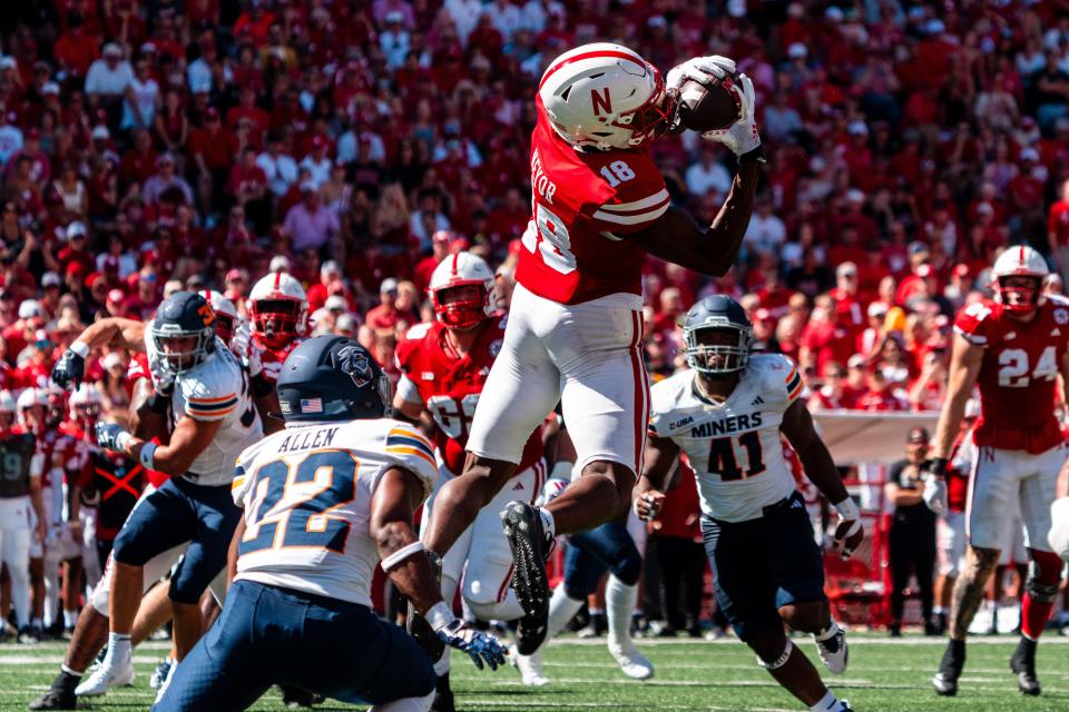 Aug 31, 2024; Lincoln, Nebraska, USA; Nebraska Cornhuskers wide receiver Isaiah Neyor (18) catches a pass against UTEP Miners linebacker Josiah Allen (22) during the second quarter at Memorial Stadium. Mandatory Credit: Dylan Widger-USA TODAY Sports