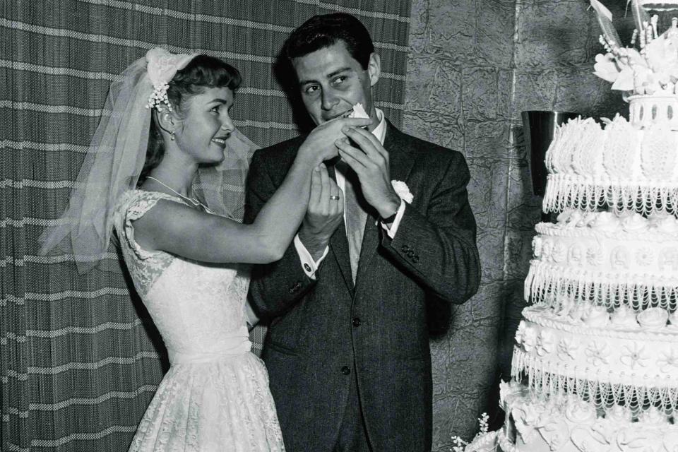 <p>Bettmann Archive</p> Debbie Reynolds and Eddie Fisher at their wedding