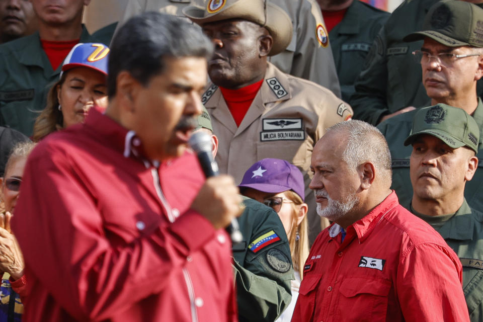 FILE - Lawmaker Diosdado Cabello, who is also Vice-President of the ruling United Socialist Party of Venezuela, listens to President Nicolas Maduro as they hold a rally marking the 21st anniversary of late President Hugo Chavez's return to power after a failed coup attempt against him, in Caracas, Venezuela, April 13, 2023. Cabello has insisted that the opposition will not manage to hold a primary election, which they are scheduling for Oct. 22, 2023 to elect a candidate to face Maduro at the ballot box. (AP Photo/Jesus Vargas, File)