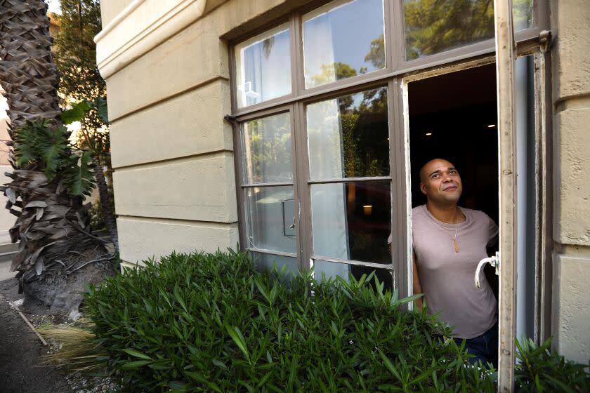 WEST HOLLYWOOD, CA - SEPTEMBER 2, 2022 - - Justin Bolding looks outside his apartment window where family and friends would talk to him while he suffered for three weeks with Monkeypox at the historic Hayworth Tower in West Hollywood on September 2, 2022. Bolding lost wages during his recovery from the virus. His mother helped by paying a month worth of his bills and had groceries delivered to him. Bolding also manages the apartments at the historic Hayworth Tower. (Genaro Molina / Los Angeles Times)