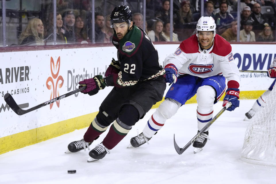 Arizona Coyotes center Jack McBain (22) skates with the puck against Montreal Canadiens defenseman Johnathan Kovacevic (26) during the third period of an NHL hockey game Thursday, Nov. 2, 2023, in Tempe, Ariz. (AP Photo/Ross D. Franklin)