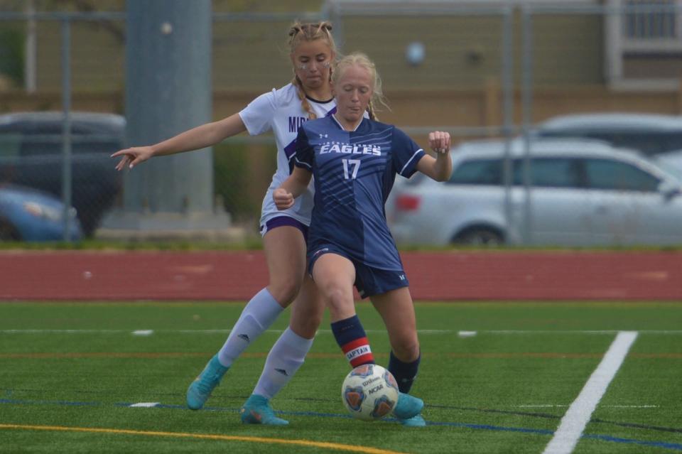 Liberty Common soccer player Makena Feist fights for a loose ball during a Class 3A playoff game against Middle Park played at Fossil Ridge on May 13, 2023. Liberty Common won 1-0 to advance to the quarterfinals.