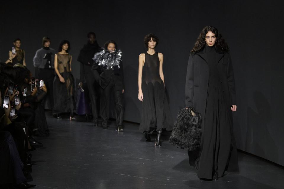 a group of people walking down a runway