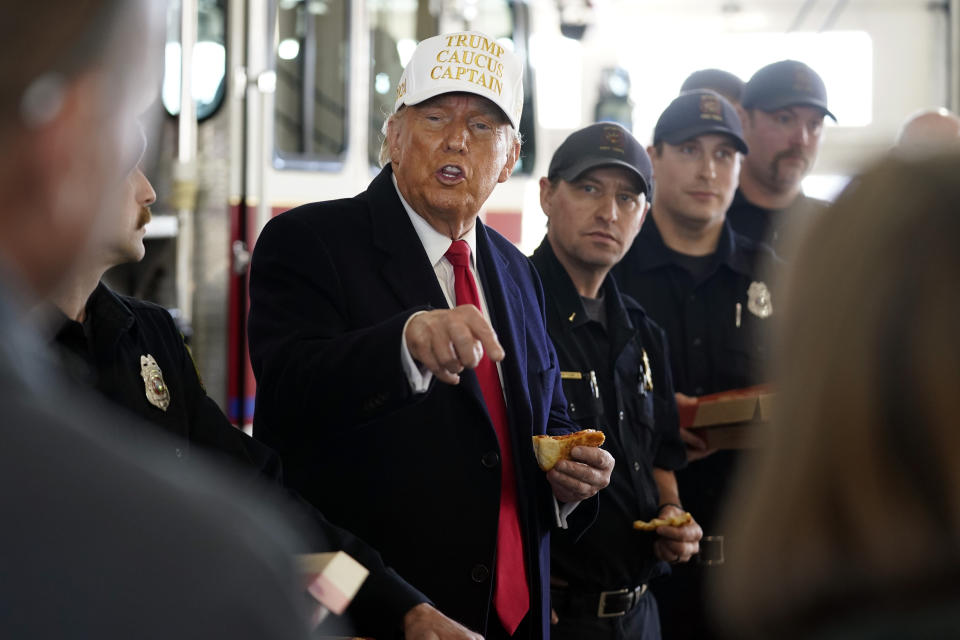 Republican presidential candidate former President Donald Trump eats pizza with fire fighters at Waukee Fire Department in Waukee, Iowa, Sunday, Jan. 14, 2024. (AP Photo/Andrew Harnik)