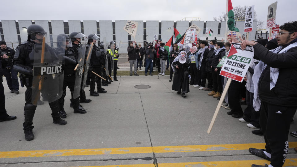 Pro-Palestinian demonstrators march against police during a visit by President Joe Biden in Warren, Mich., Thursday, Feb. 1, 2024. (AP Photo/Paul Sancya)