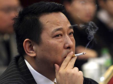 Liu Han, former chairman of Hanlong Mining, smokes a cigarette during a conference in Mianyang, Sichuan province, in this file picture taken March 21, 2008. REUTERS/Stringer/Files