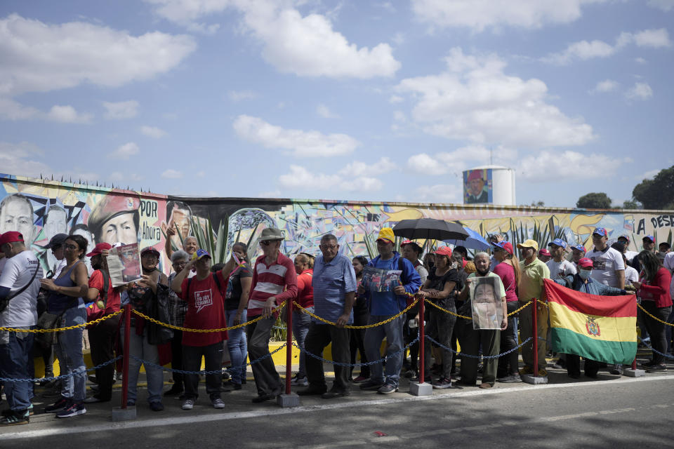 People line up to visit the tomb of late Venezuelan President Hugo Chavez during commemorations marking the tenth anniversary of his death, outside the Cuartel de la Montaña 4F where his remains are interred in Caracas, Venezuela, Sunday, March 5, 2023. Chavez died on March 5, 2013, after a long battle with cancer and chose current president, Nicolas Maduro, a former bus driver and union leader to be his successor. (AP Photo/Ariana Cubillos)