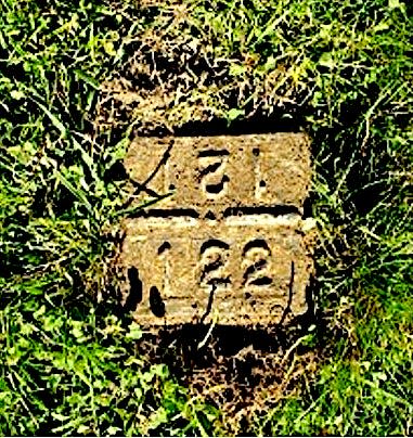 The original numbered marker over Ken Lewis’ remains at St. Joseph Cemetery in West Greenwich.