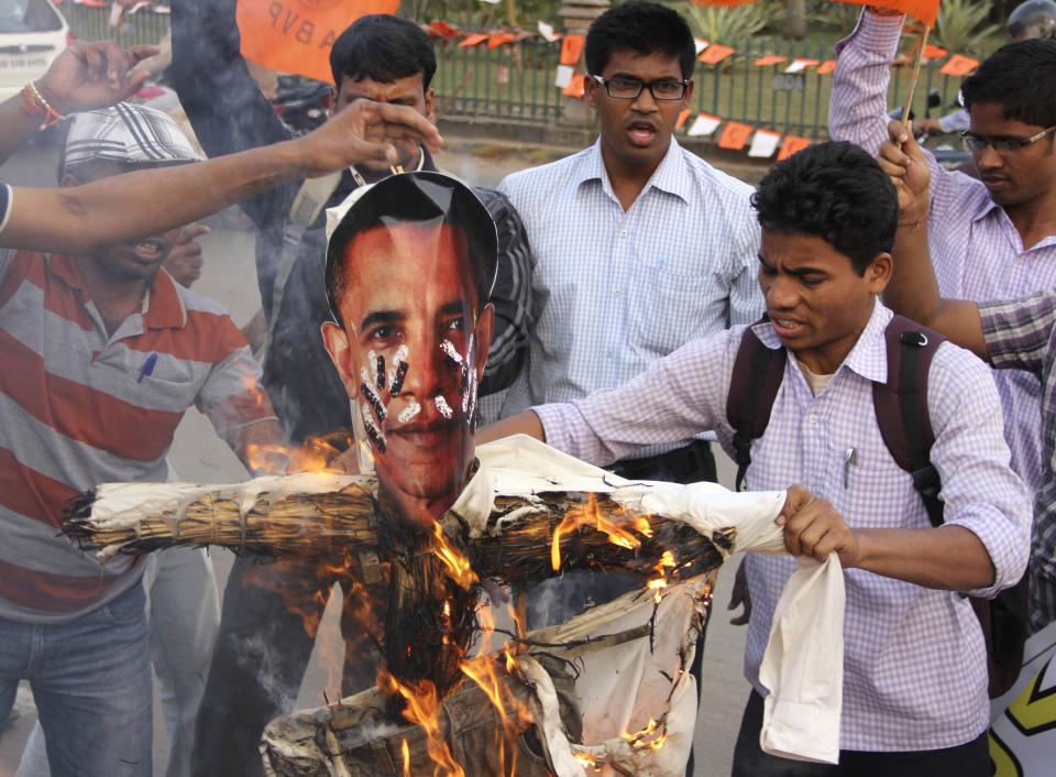 Activists of Akhil Bharatiya Vidyarthi Parishad (ABVP), linked to India's main opposition Bharatiya Janata Party (BJP), burn an effigy depicting U.S. President Barack Obama during a protest in the eastern Indian city of Bhubaneswar December 19, 2013. India urged the United States to withdraw a visa fraud case against one of its diplomats in New York on Thursday, suggesting U.S. Secretary of State John Kerry's expression of regret over her treatment while in custody was not enough. The arrest of Devyani Khobragade on charges of underpaying her nanny and her subsequent strip-search has touched off a furore within the Indian foreign service and put an unexpected strain on ties between the two countries. <br>(REUTERS/Stringer)